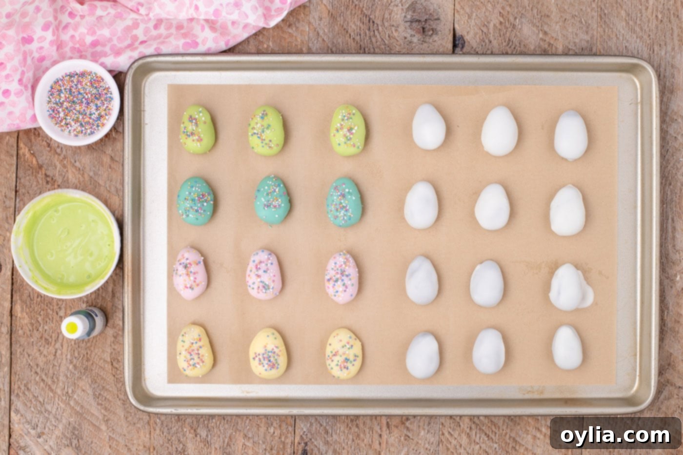 Pastel colored Oreo truffles on a baking sheet with sprinkles for Easter