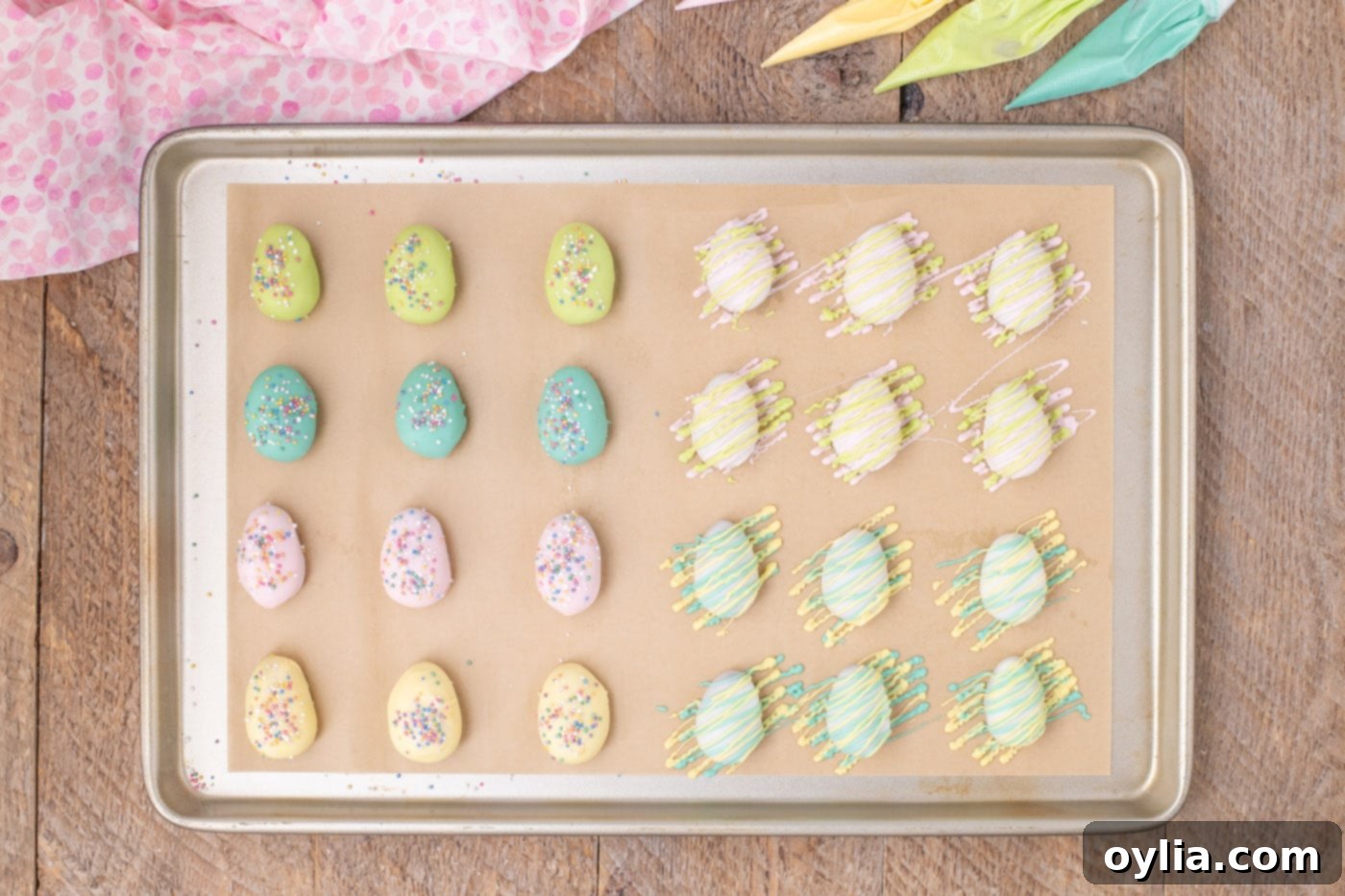 Easter egg truffles decorated in pastel colors and sprinkles, some with drizzles