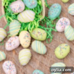 Close up photo of Easter Egg Oreo Truffles falling out of an Easter basket, with pastel sprinkles