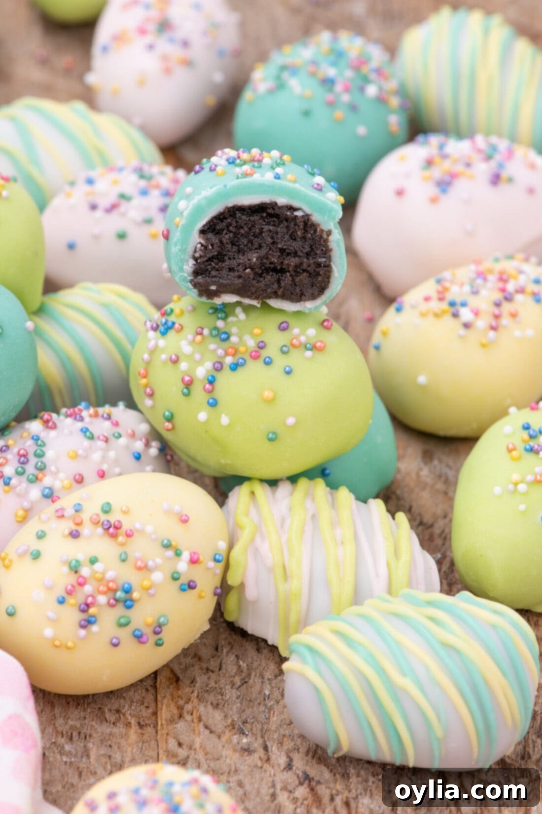 Easter Egg Oreo Truffles with a bite taken out of one, showing the rich chocolate interior