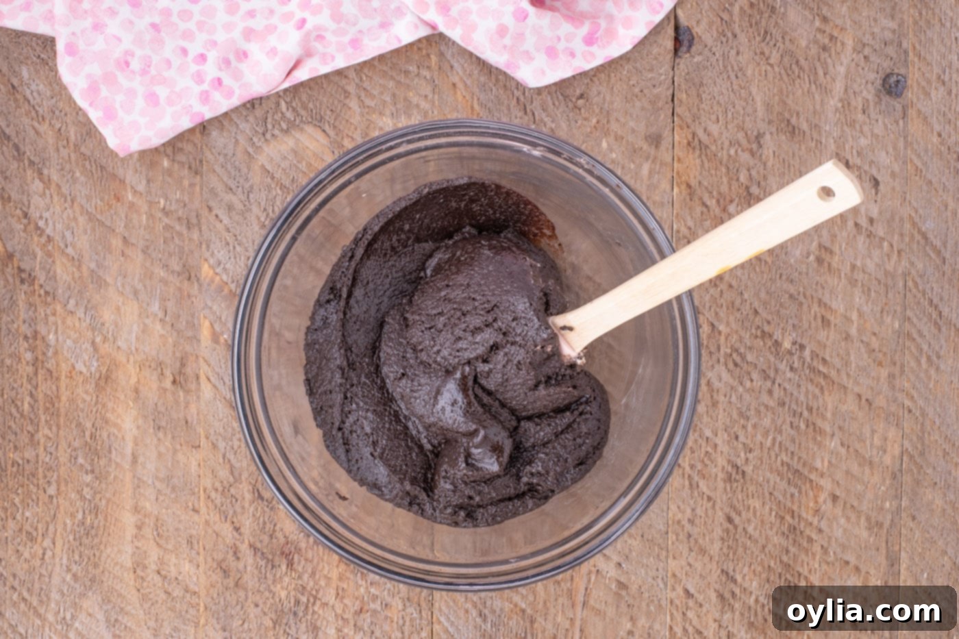 Cream cheese and Oreo crumble mixture being stirred in a bowl