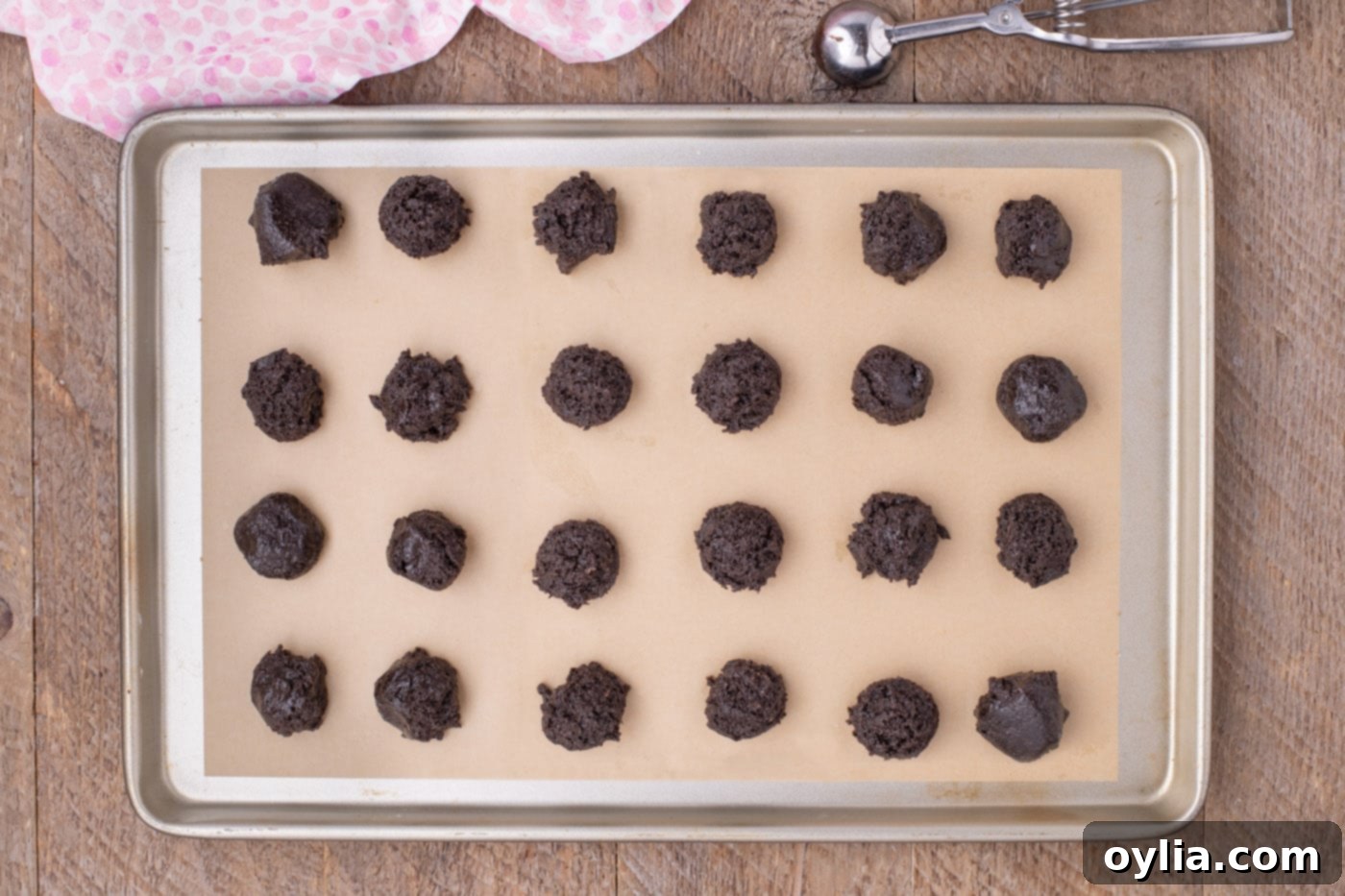 Oreo mixture scooped onto a baking sheet, ready for shaping
