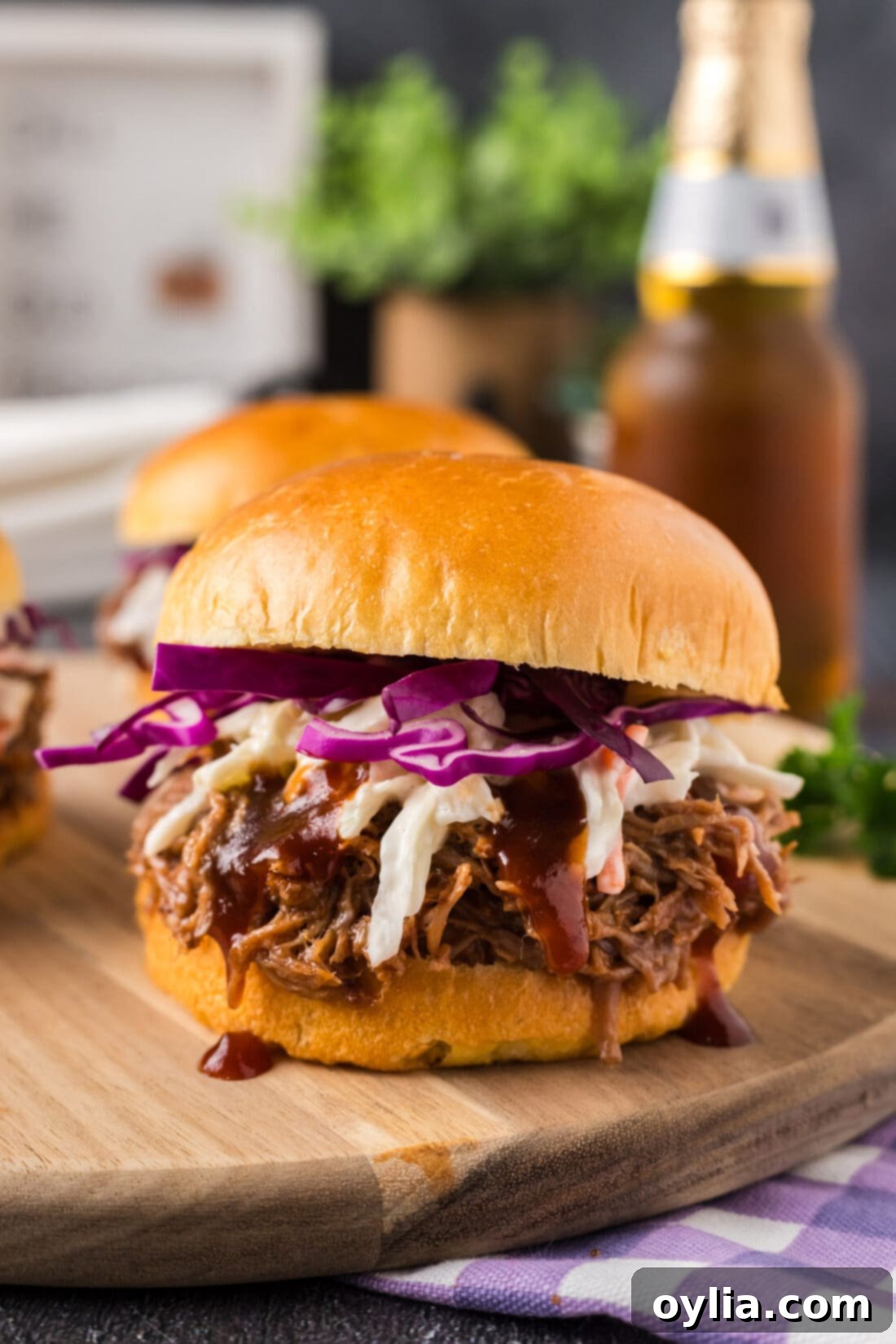 Perfectly assembled Pulled Pork Sandwich on a rustic wooden board, ready to be enjoyed
