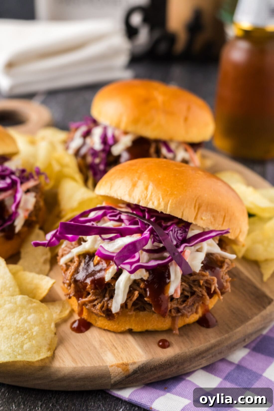 Pulled Pork Sandwich with the top bun slightly ajar, showcasing the juicy pork and coleslaw