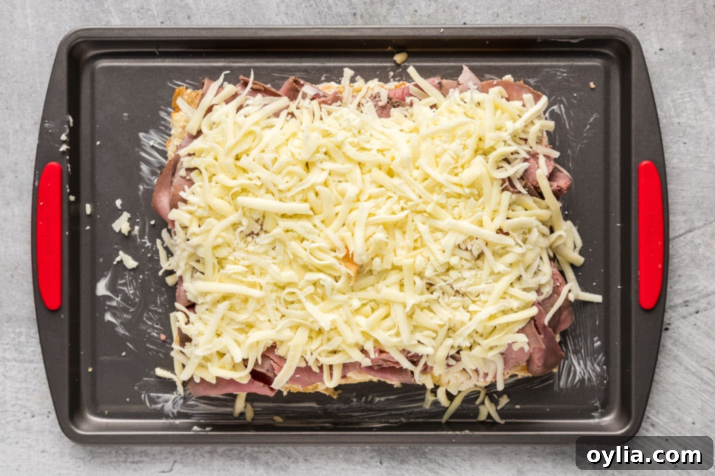 shredded mozzarella cheese over roast beef sliders