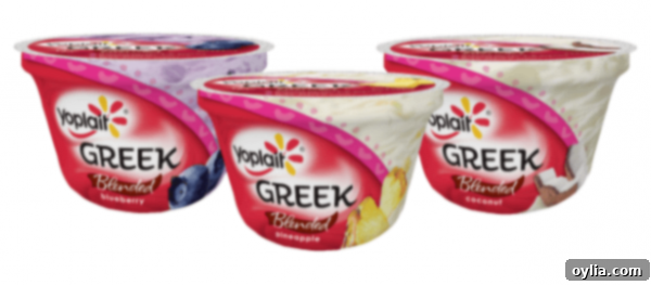 A photo of three Yoplait Greek yogurt containers.