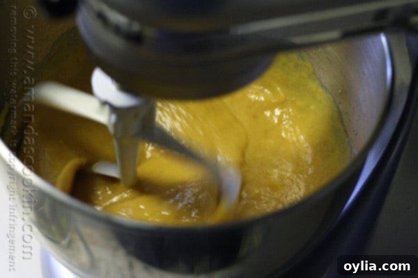 A photo of the cake batter being mixed in a stand up mixer.