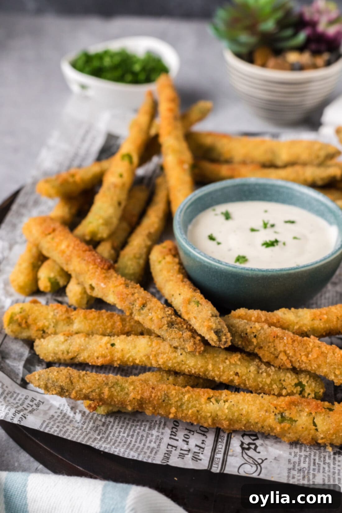 Pan-Seared Asparagus Spears 3 Fried Asparagus on a plate with ranch for dipping in a bowl