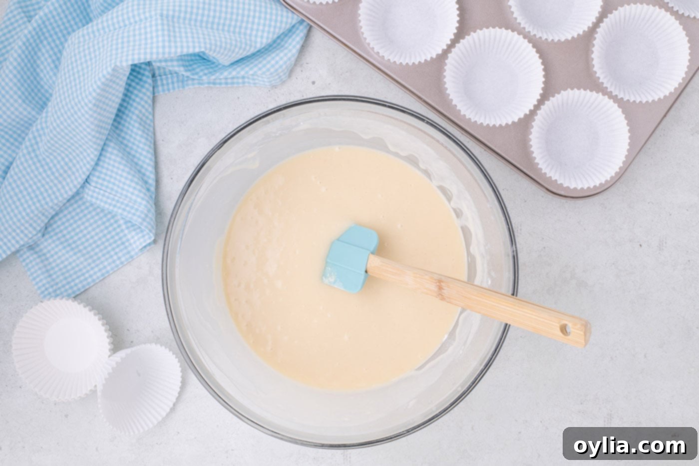rubber spatula in a bowl of vanilla cupcake batter
