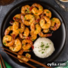 Glazed Honey Garlic Shrimp 12 Honey Garlic Shrimp on a plate with rice and chopsticks