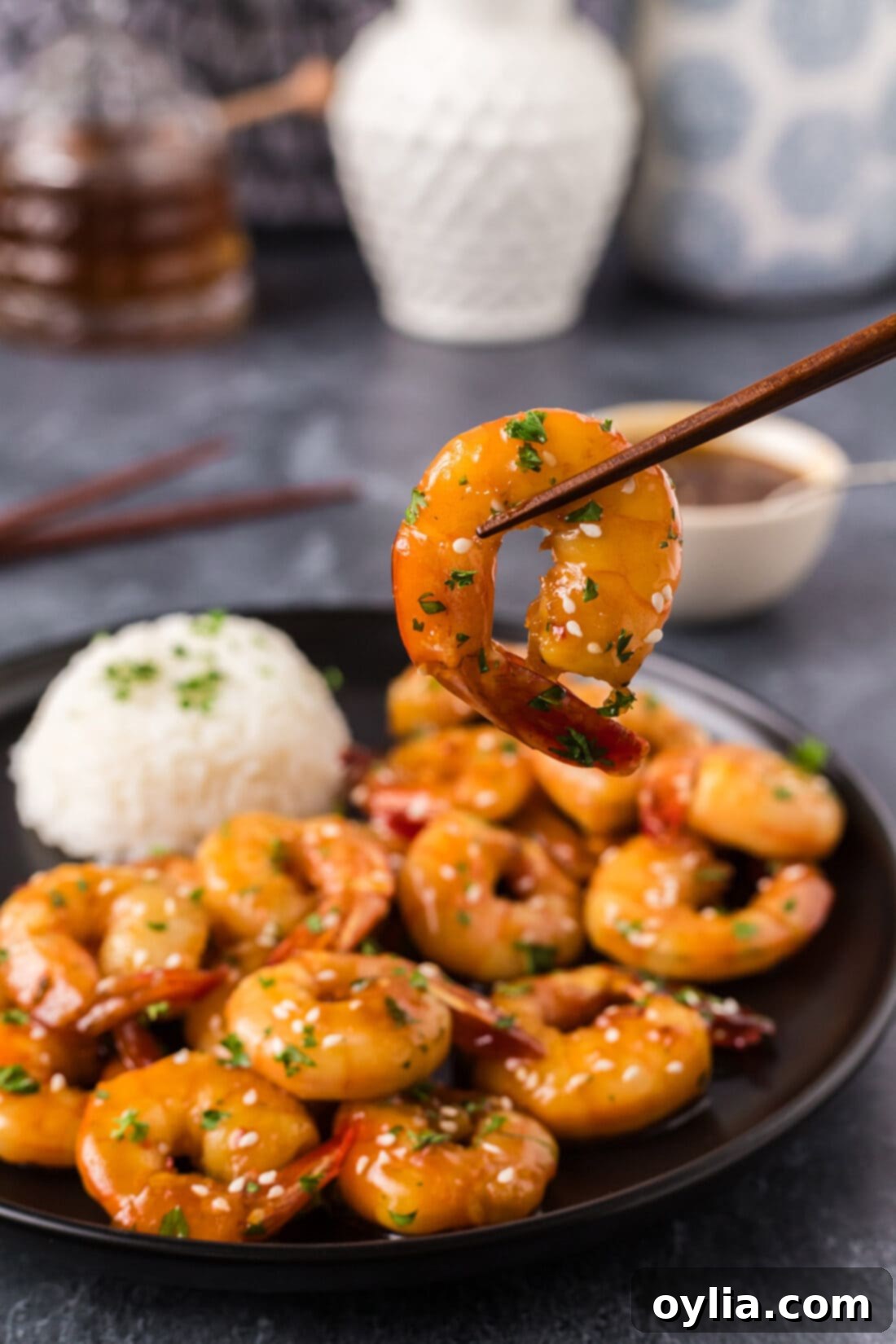 Glazed Honey Garlic Shrimp 3 Honey Garlic Shrimp held up by chopsticks