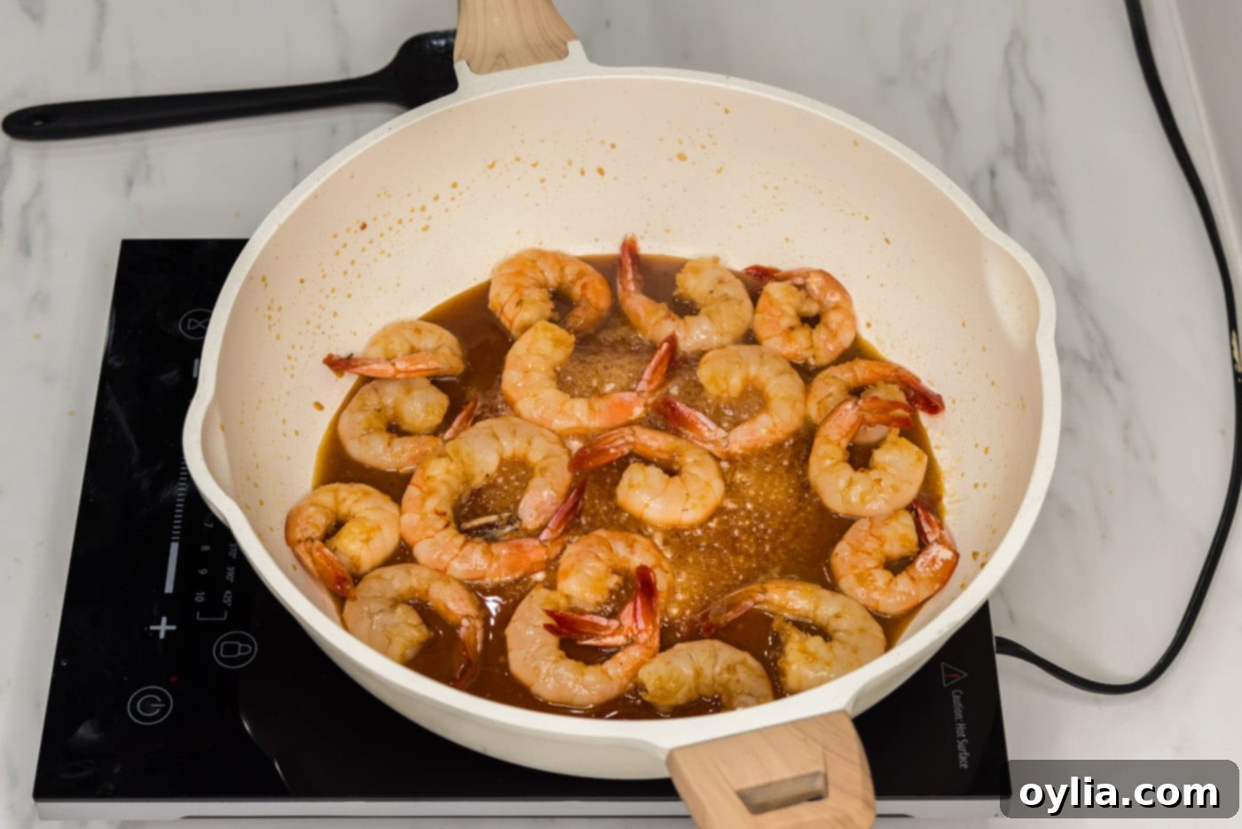 cooked shrimp in skillet with honey garlic sauce