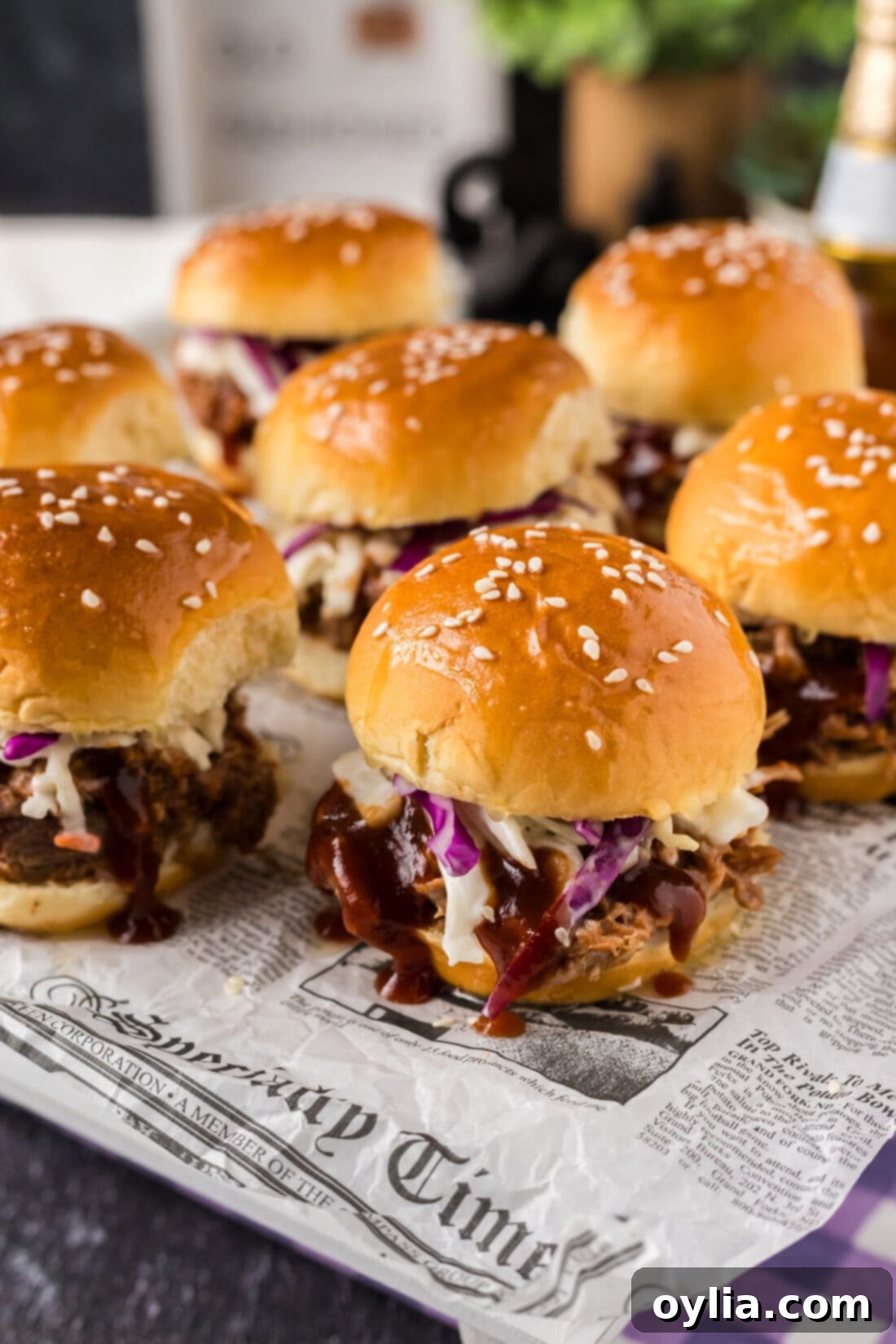 Pulled Pork Sliders arranged neatly on parchment paper, ready to be served