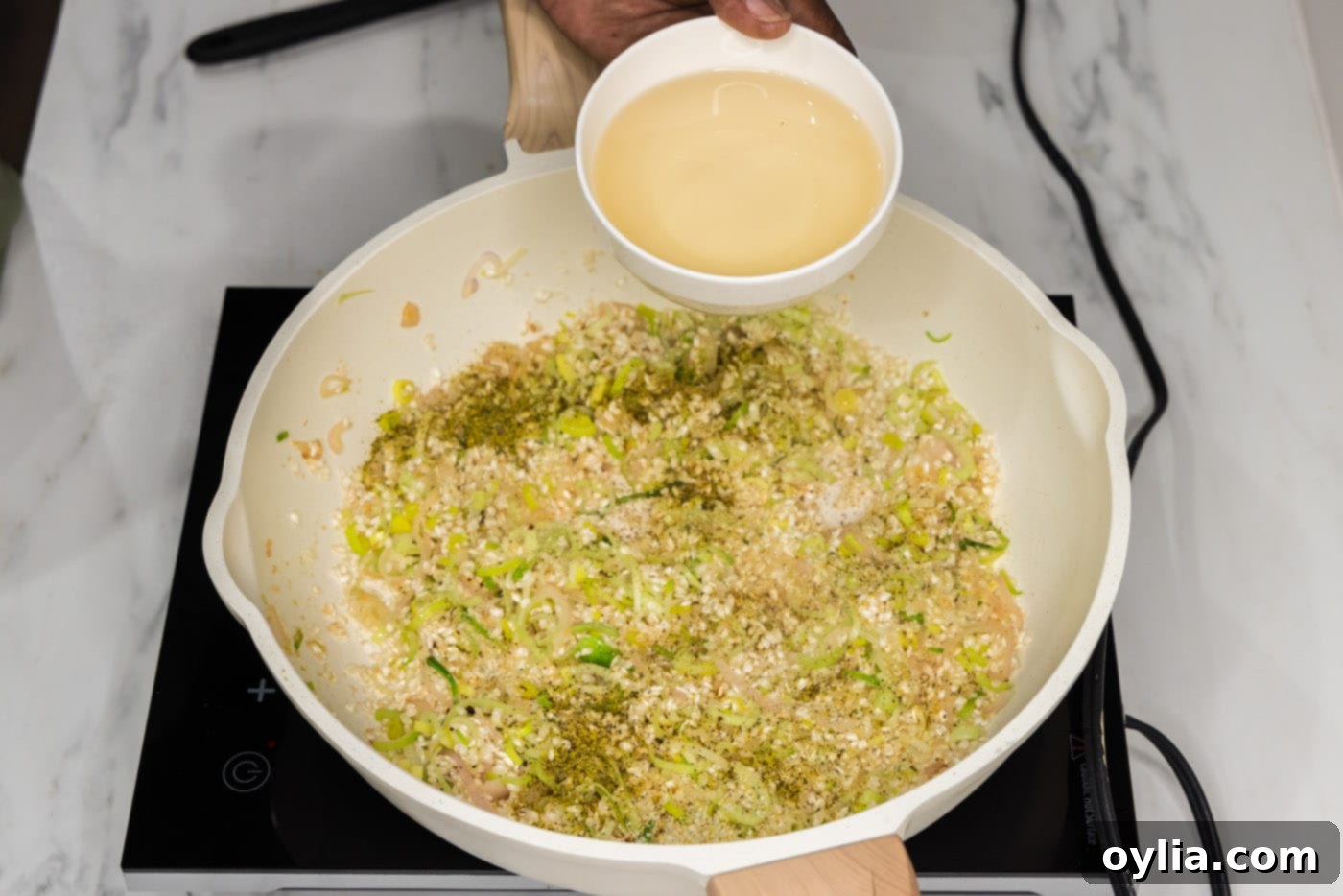 adding white wine to skillet with risotto mixture