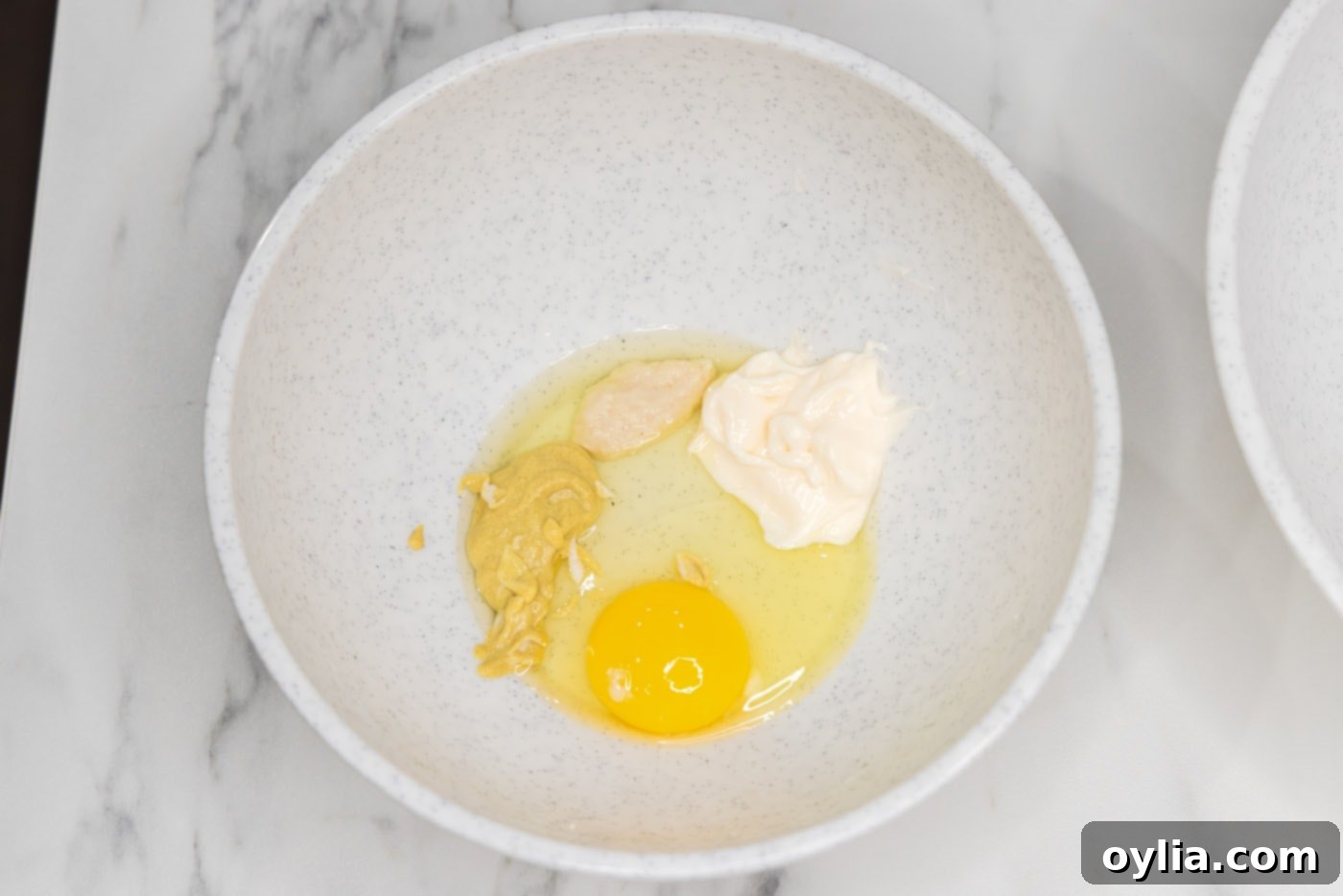 egg, horseradish, mayonnaise, and Dijon mustard whisked together in a bowl