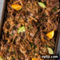 Crispy Instant Pot Carnitas 16 Close up photo of Instant Pot Carnitas on a sheet pan, showing crispy edges and tender shredded pork.