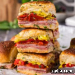 Close up photo of a stack of Italian Sliders with melted cheese and meats