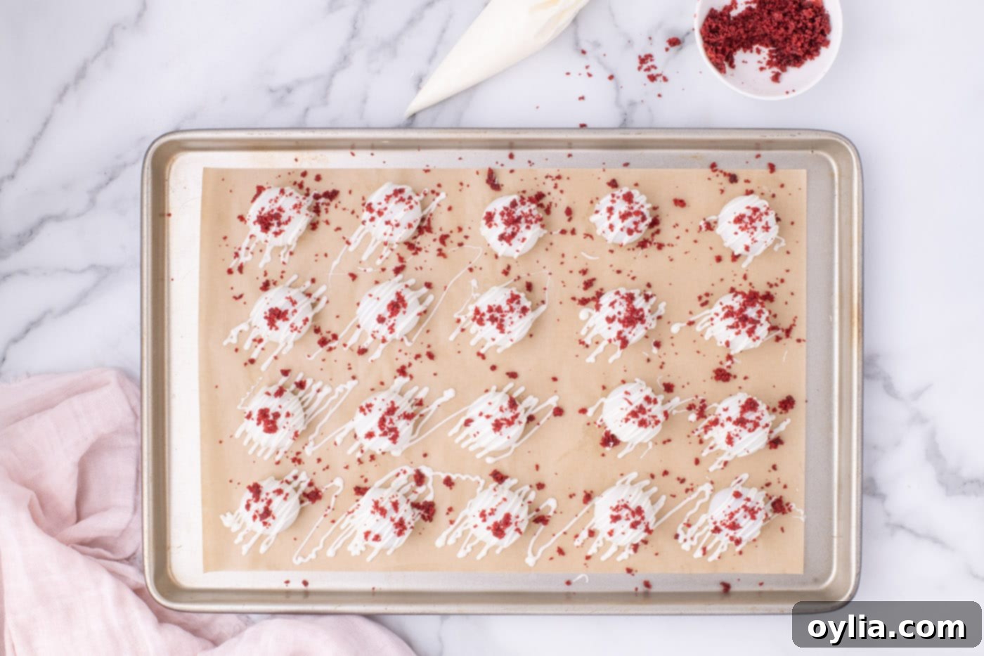 Overhead shot of freshly made Red Velvet Cake Balls arranged neatly on a baking sheet