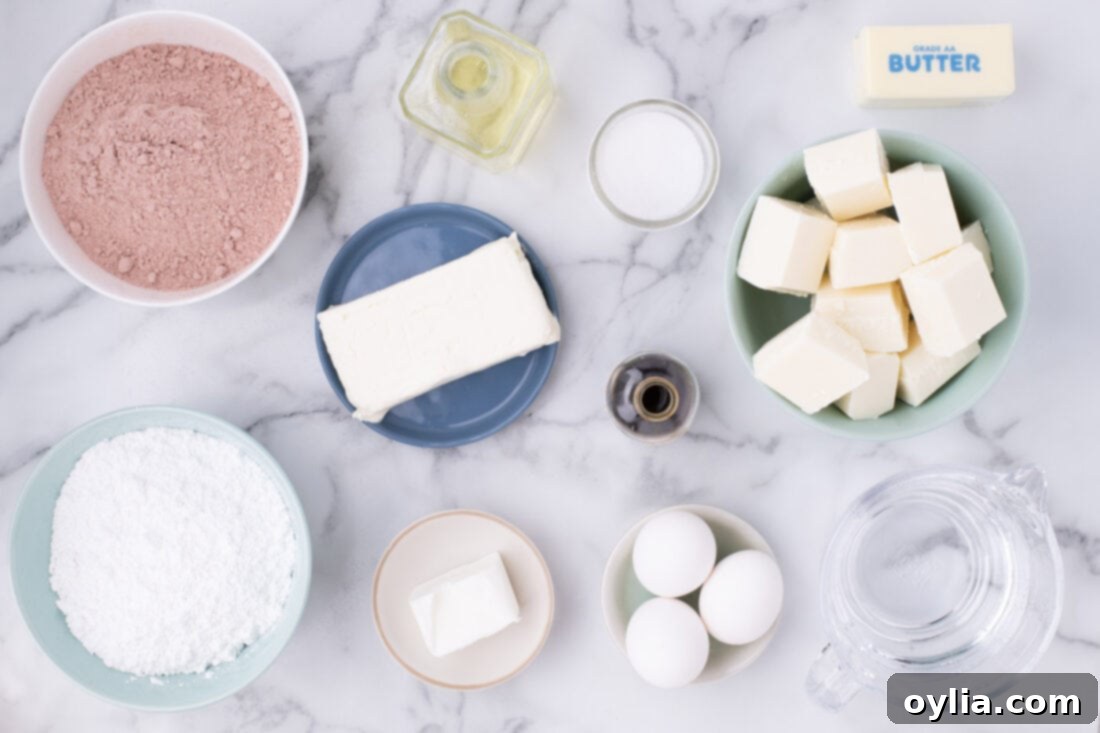 All ingredients for making Red Velvet Cake Balls laid out on a table: cake mix, butter, cream cheese, powdered sugar, vanilla, salt, almond bark, and vegetable shortening.