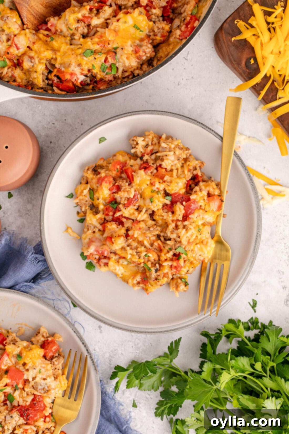 Hearty Stuffed Pepper Bake 12 A serving of Stuffed Pepper Casserole, garnished with fresh parsley, on a white plate with a fork ready to enjoy.