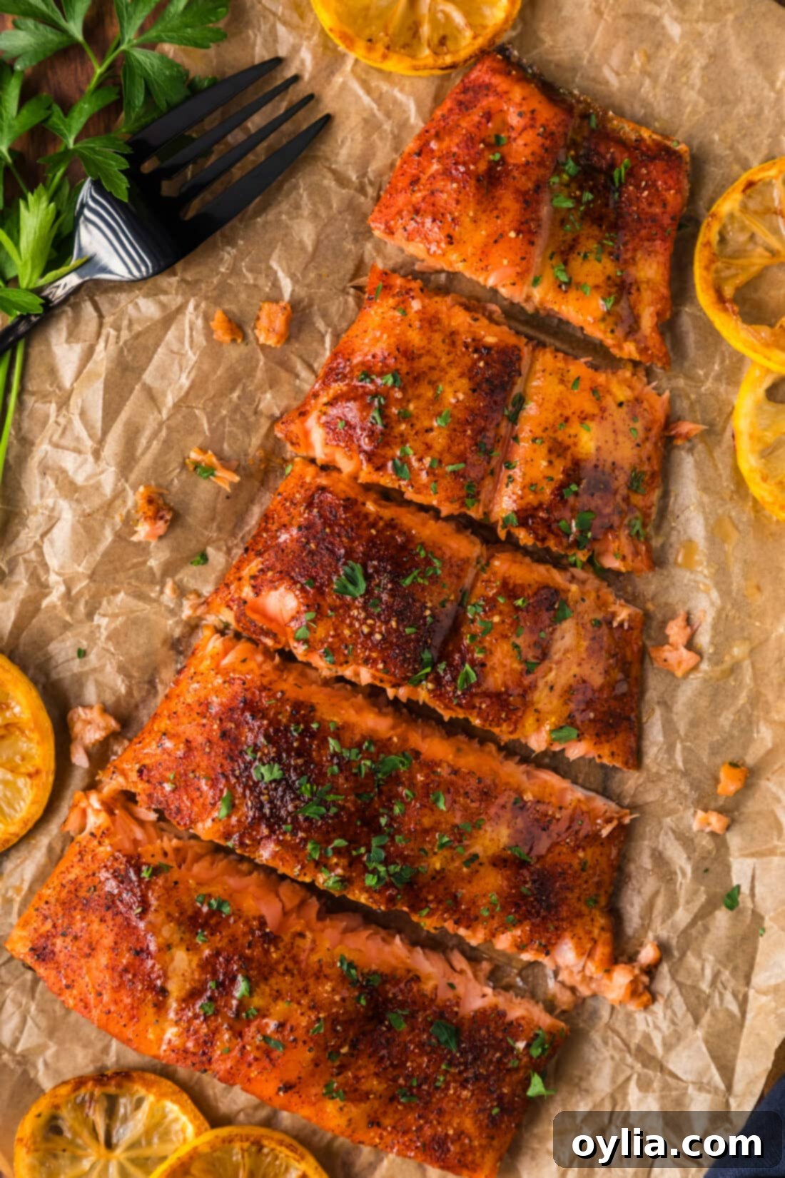 Fresh salmon filets, prepared and ready for smoking, resting on parchment paper