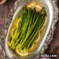 Tender Steamed Asparagus 10 Steamed Asparagus resting on lemon slices on a platter
