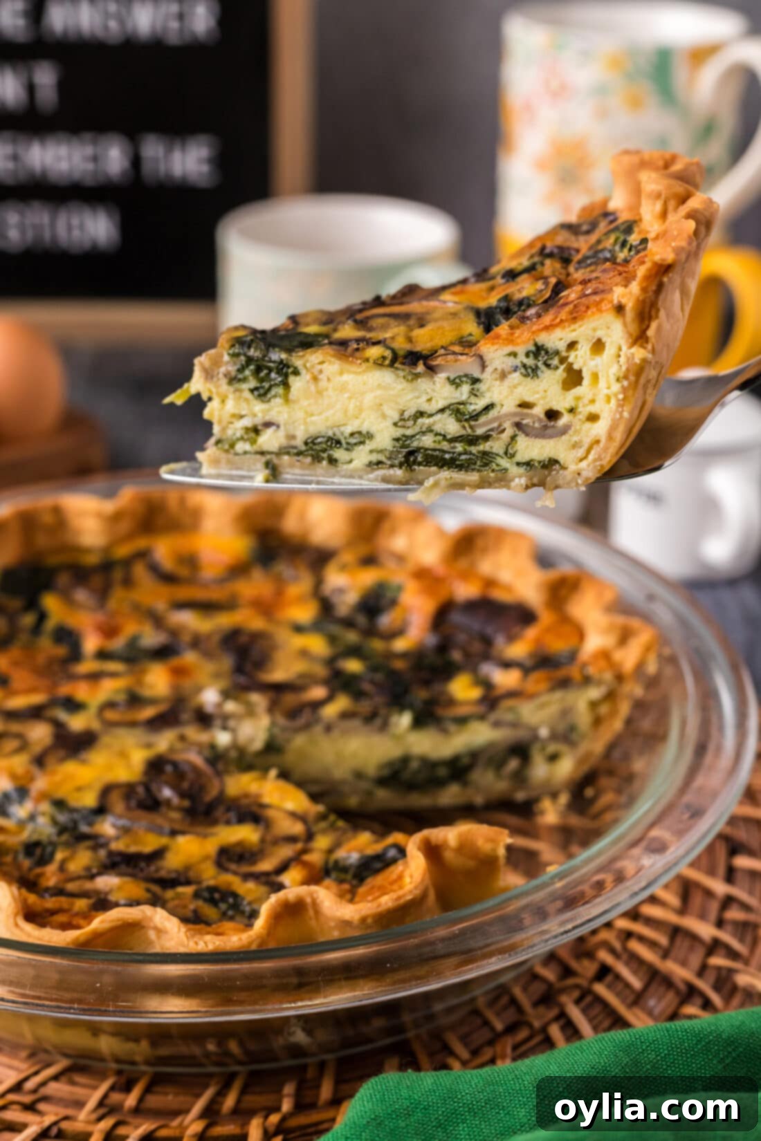 Savory Spinach Mushroom Quiche 2 Slice of Spinach Mushroom Quiche being lifted out of the pie plate