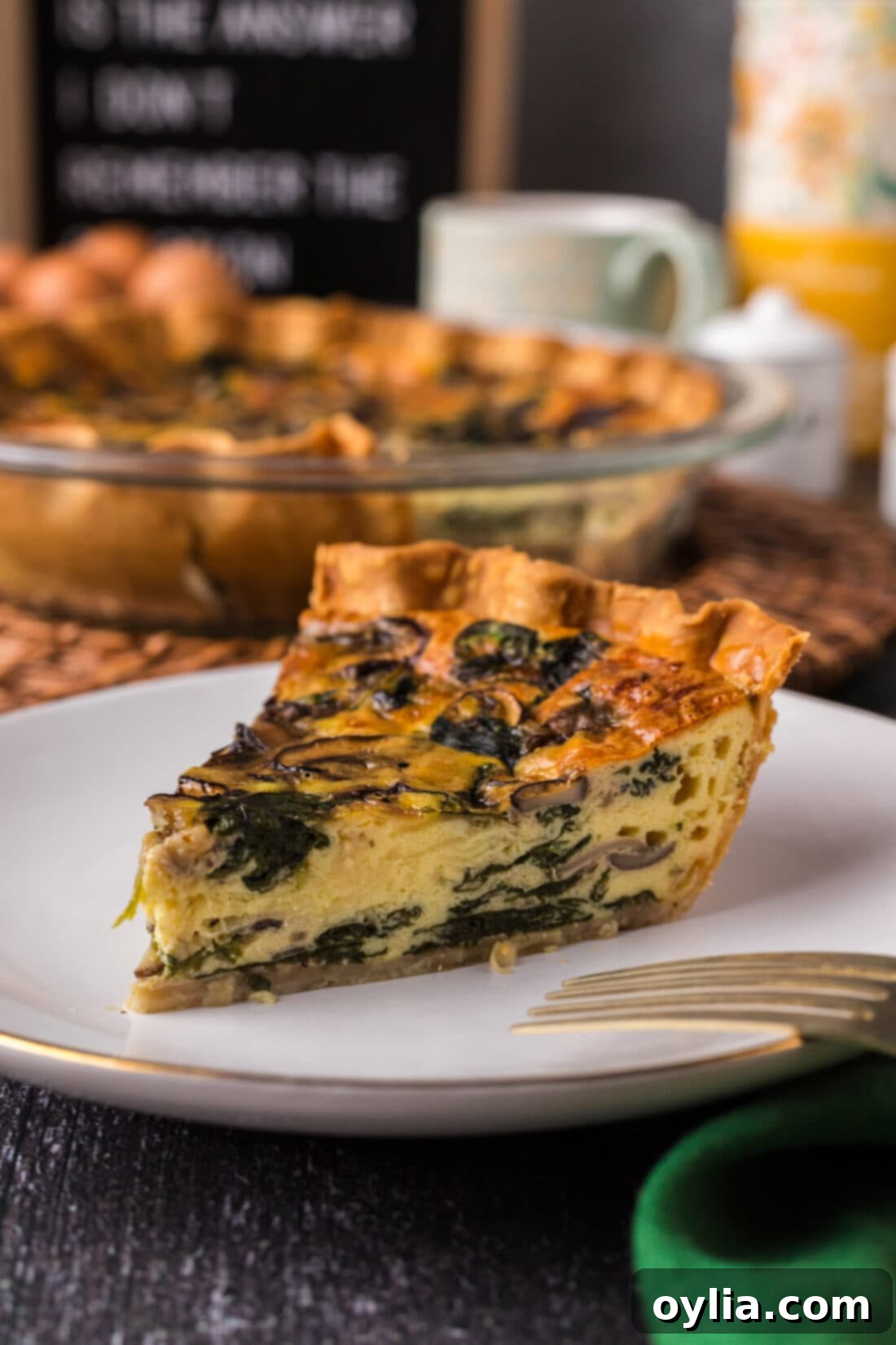 Savory Spinach Mushroom Quiche 14 Slice of Spinach Mushroom Quiche on a plate