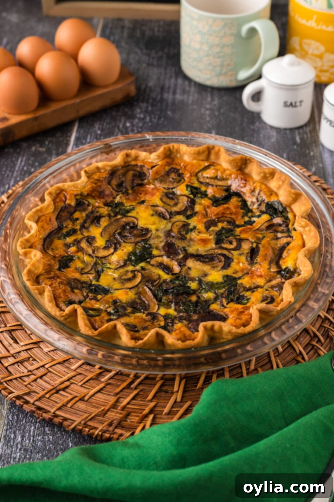 Savory Spinach Mushroom Quiche 3 Spinach Mushroom Quiche on a wooden charger
