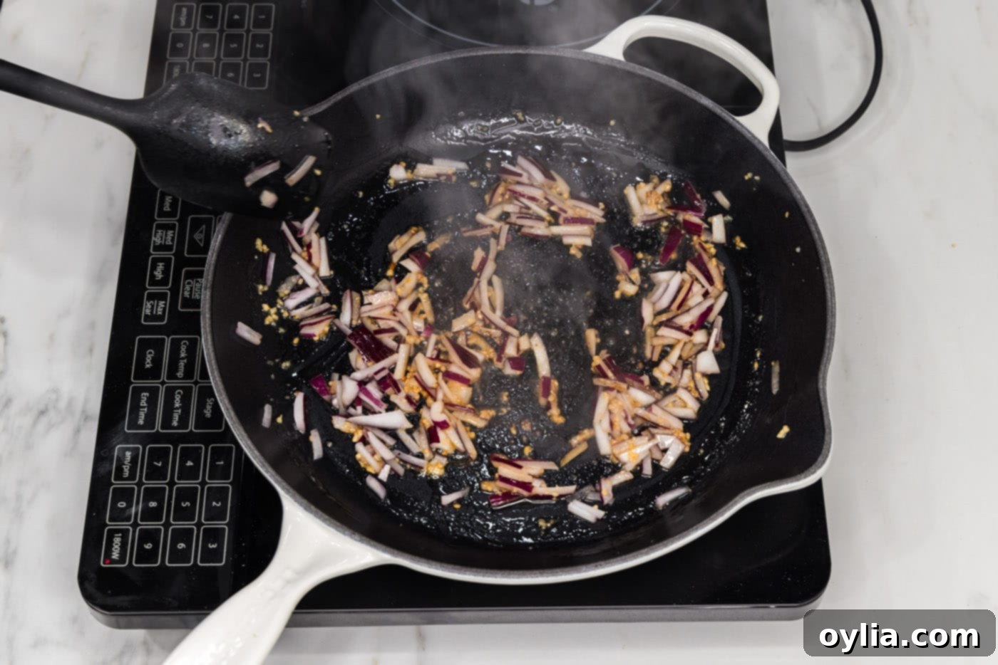 sauteeing red onion and garlic in a skillet