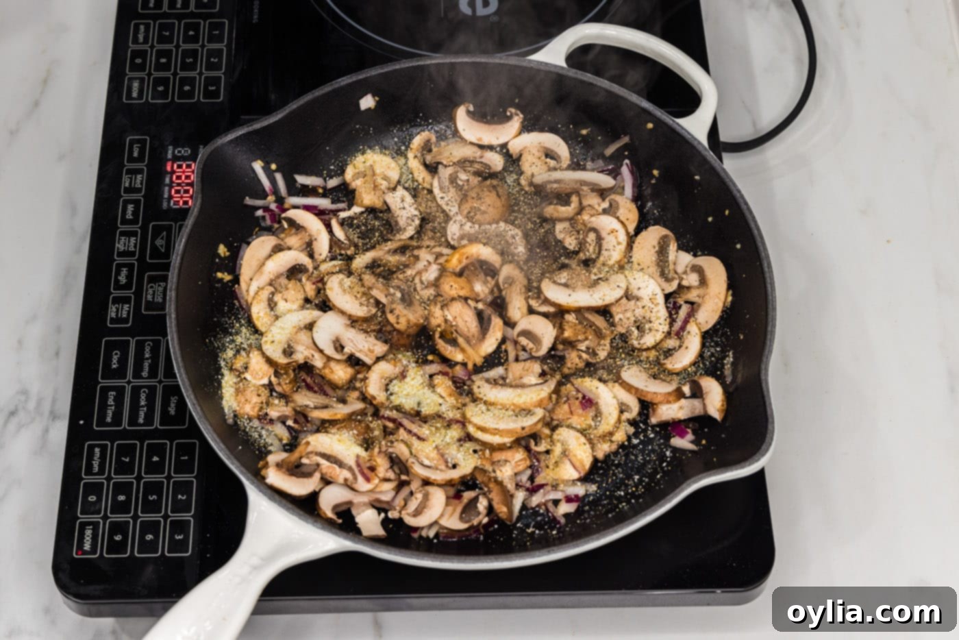 sliced mushrooms added to skillet with garlic and onion