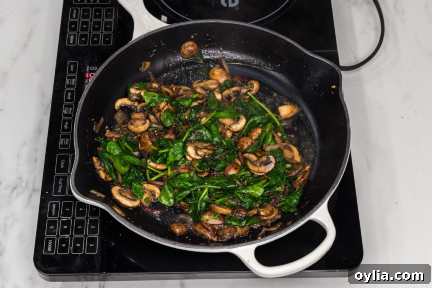 sauteed spinach and mushrooms in a skillet