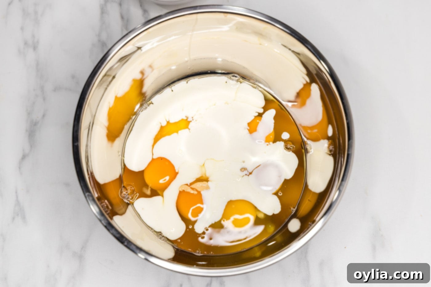 heavy cream, Dijon mustard, and eggs in a bowl