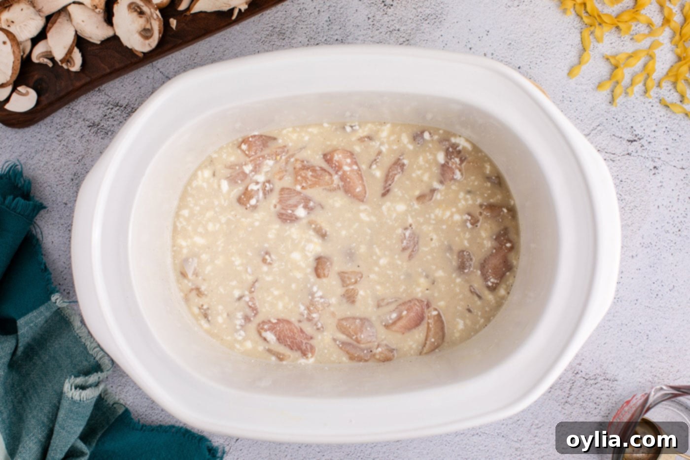 Creamy chicken stroganoff mixture in the crockpot after stirring, before adding mushrooms and cream cheese.