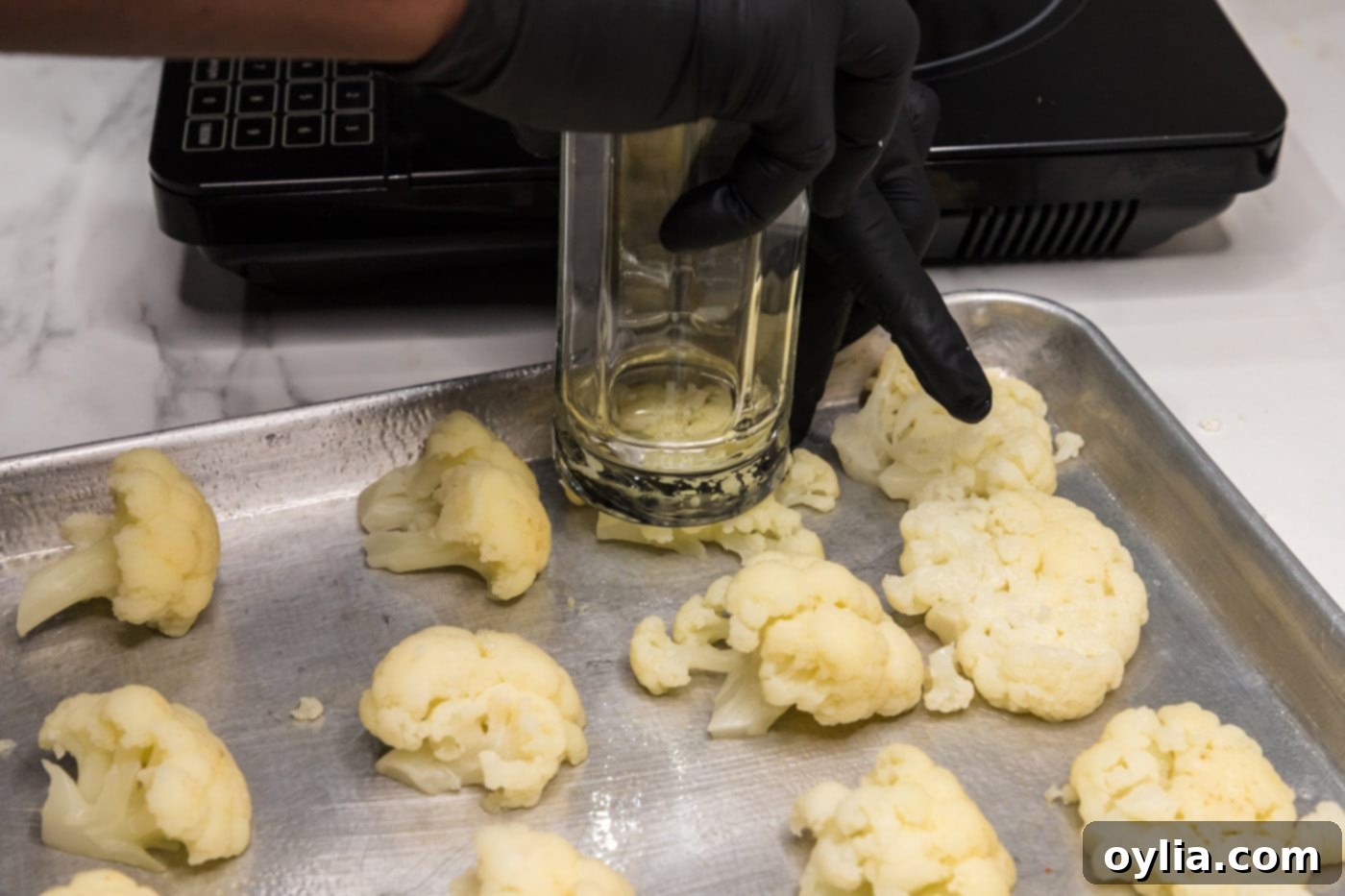 smashing cauliflower florets with the flat end of a drinking glass