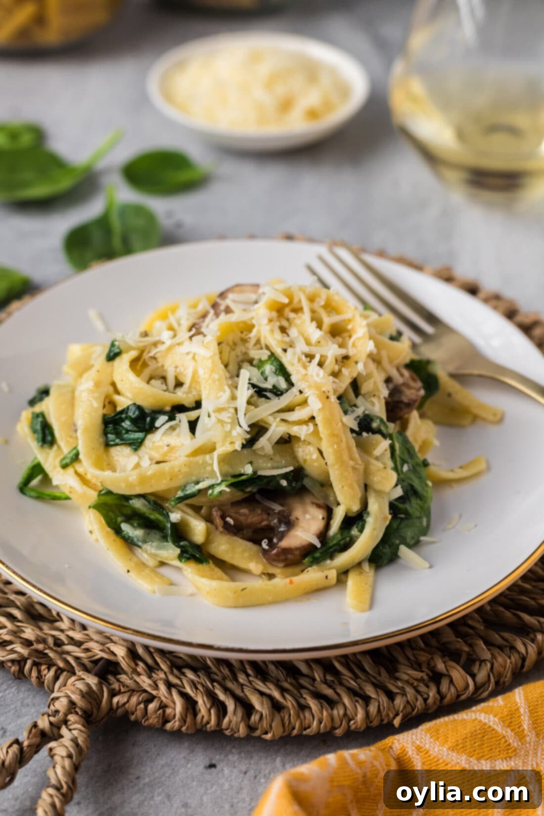 Fresh Spinach Fettuccine 3 A plate of homemade Spinach Fettuccine with a fork, showing the creamy sauce and fresh ingredients, ready to be enjoyed