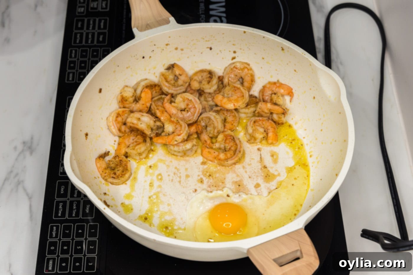 sauteed shrimp with egg in a skillet