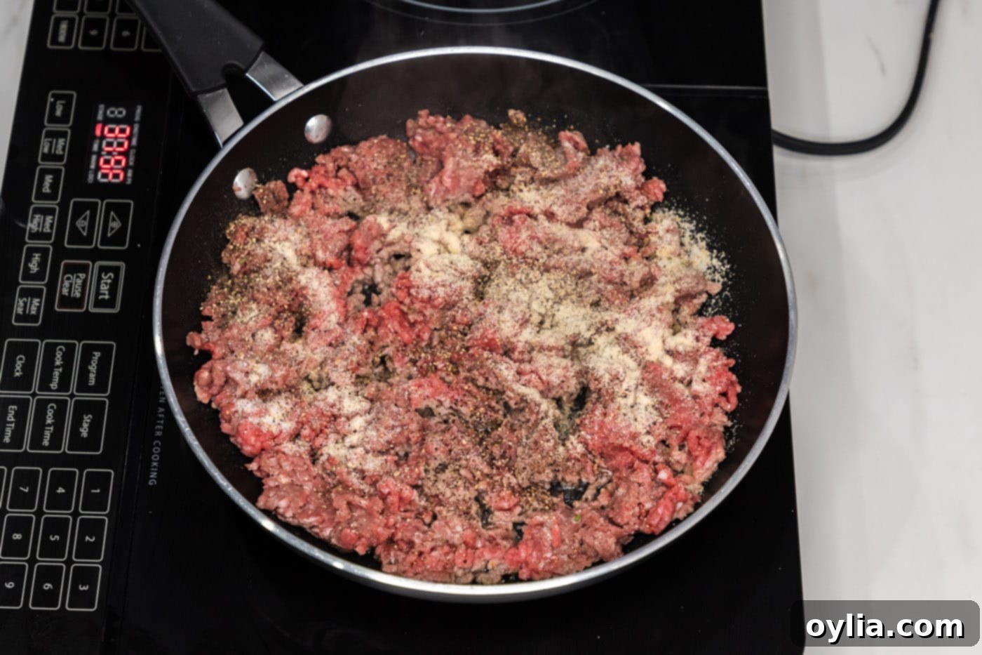 ground beef in a skillet with seasonings