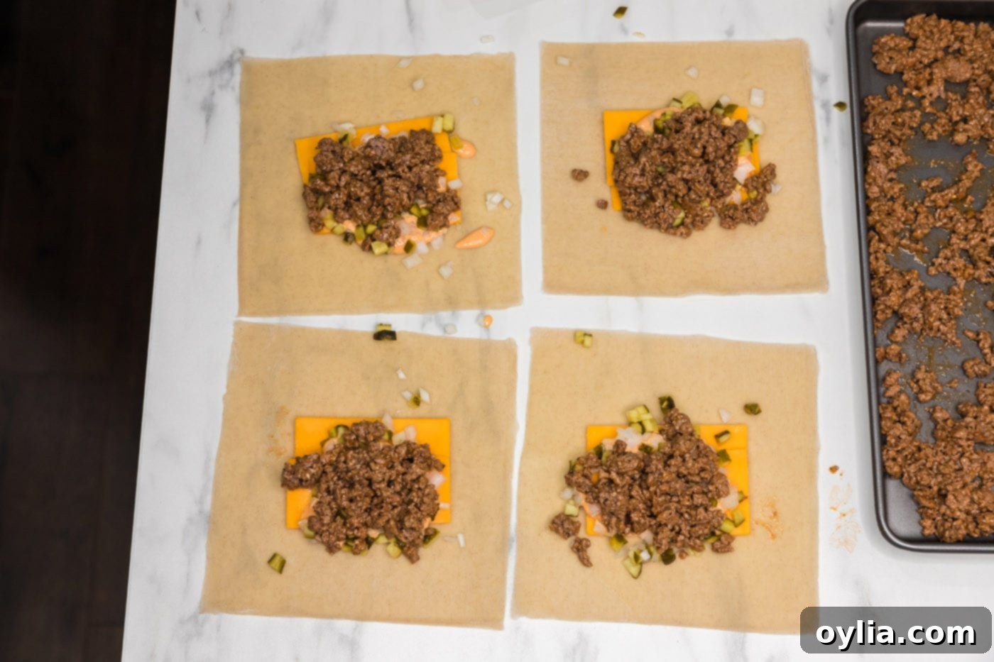 ground beef mixture placed on top of egg roll wrappers with other Big Mac ingredients