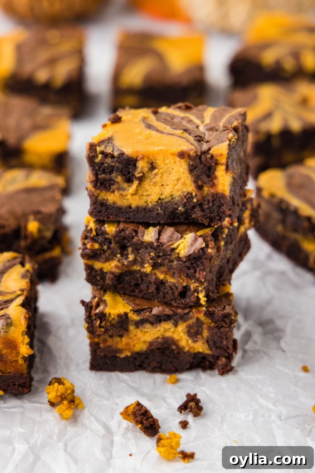 Spiced Pumpkin Swirl Cheesecake Brownies 2 Stack of three Pumpkin Cheesecake Brownies showing the distinct marbled layers