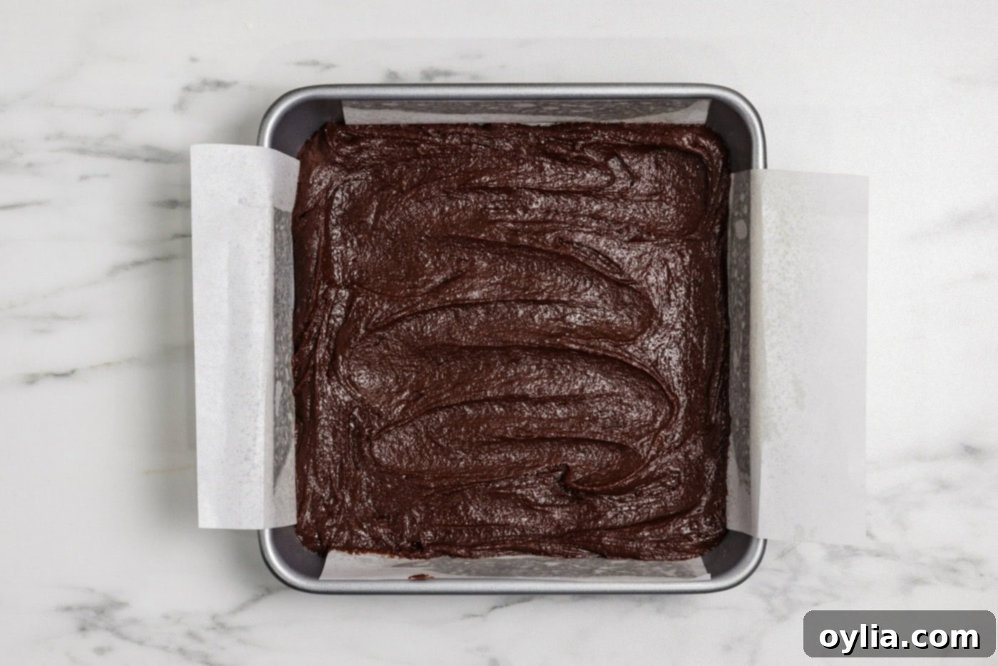 Spiced Pumpkin Swirl Cheesecake Brownies 11 Brownie batter spread evenly in a 9x9 inch baking pan