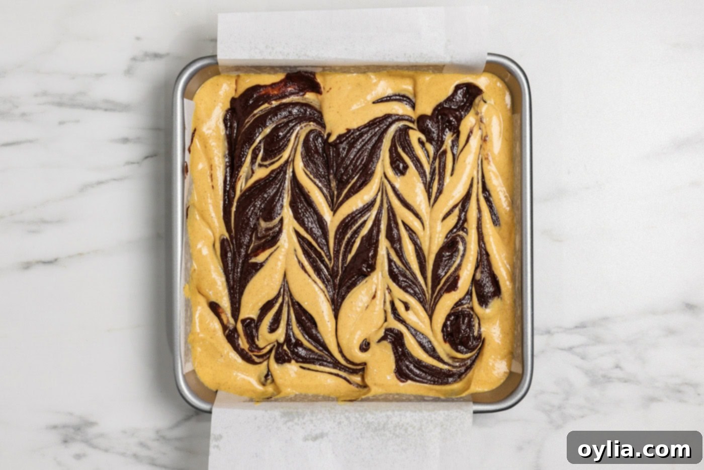 Spiced Pumpkin Swirl Cheesecake Brownies 15 Beautifully marbled swirls of brownie and pumpkin cheesecake batter in the pan, ready for baking