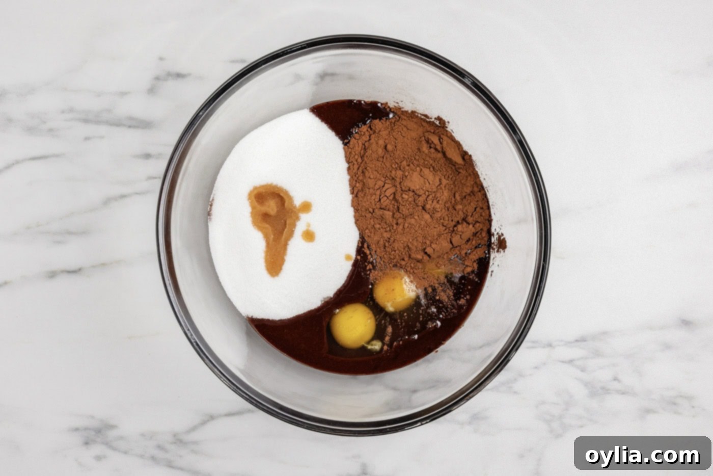 Spiced Pumpkin Swirl Cheesecake Brownies 8 Eggs, cocoa powder, sugar, and vanilla added to the melted chocolate mixture