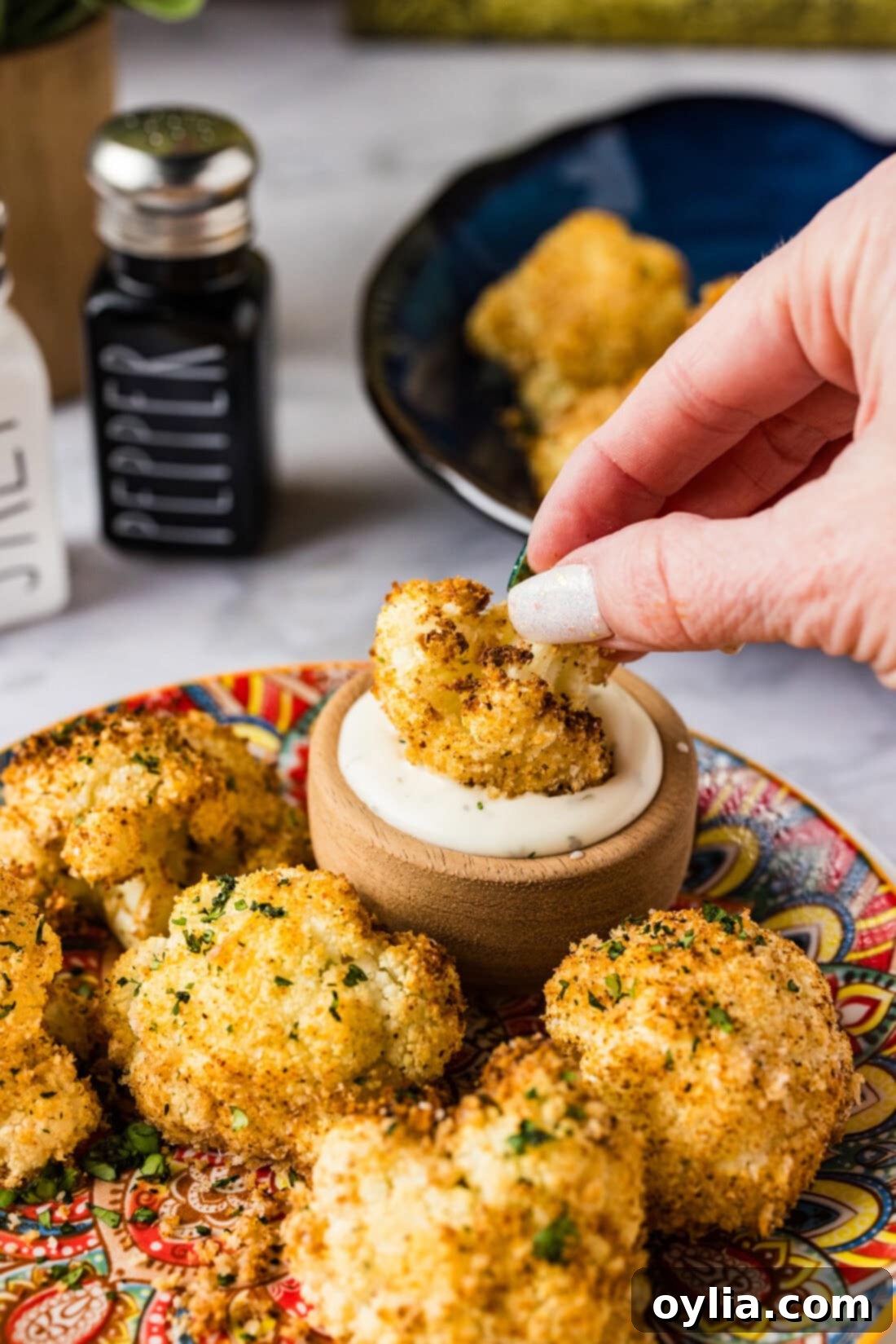 Air Fryer Fried Cauliflower being dipped in ranch