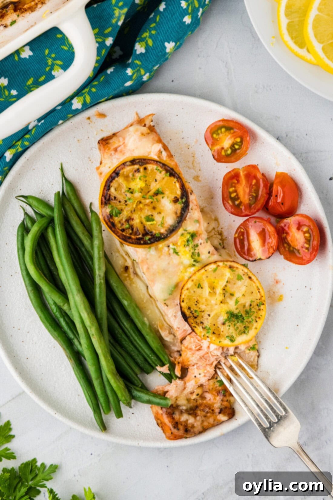 Zesty Baked Salmon 10 Baked Lemon Salmon on a plate with asparagus and tomatoes