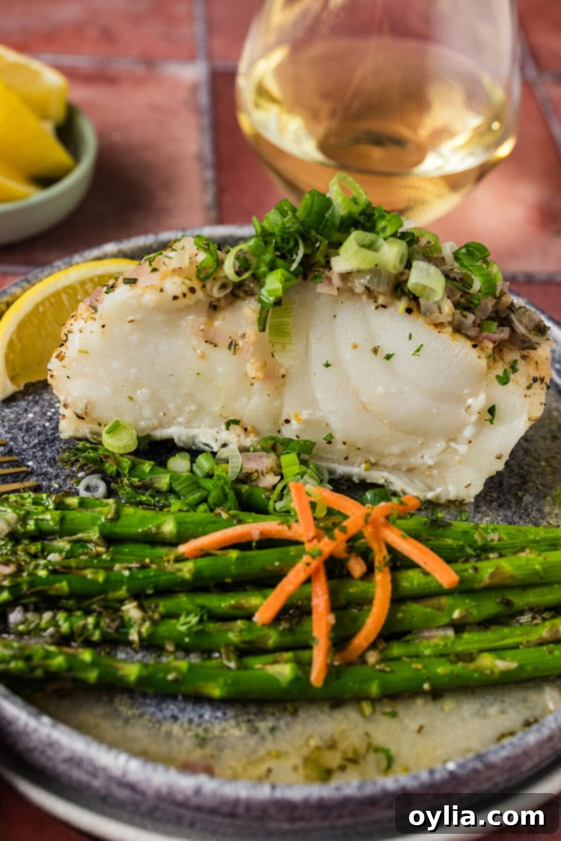 Steamed Chilean Sea Bass on a plate with asparagus