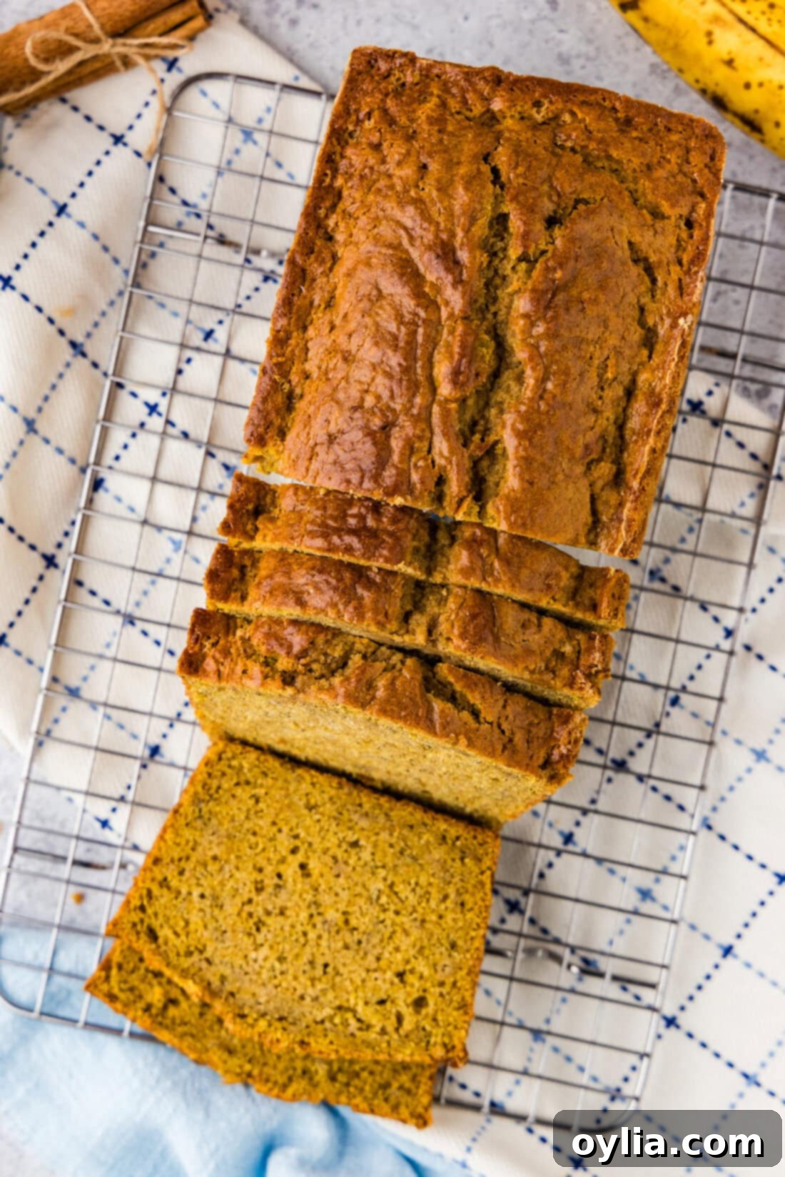 Golden Spiced Pumpkin Banana Loaf 2 Pumpkin Banana Bread cut into slices on a wire rack, a perfect fall treat