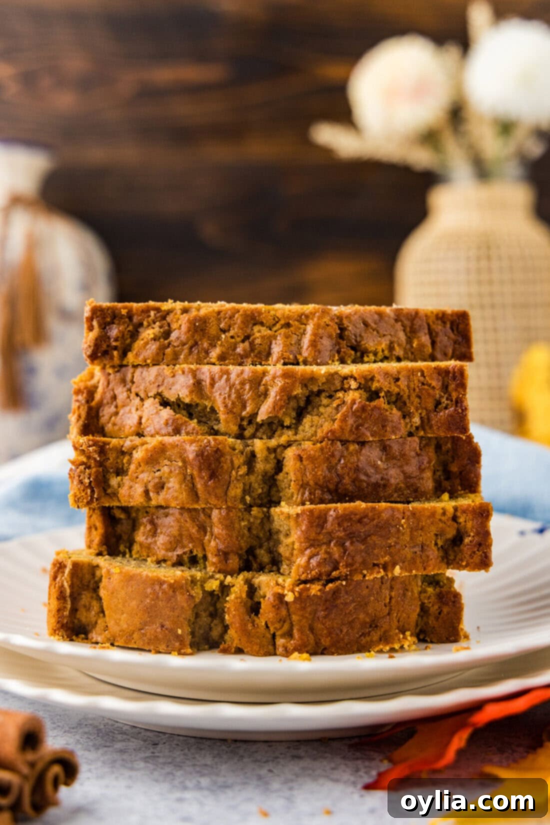 Golden Spiced Pumpkin Banana Loaf 3 Stack of freshly baked Pumpkin Banana Bread slices on a plate