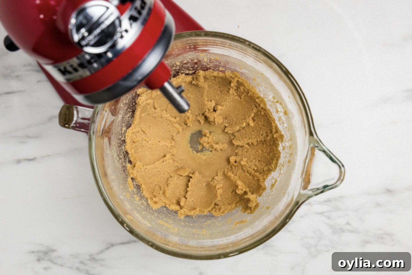 butter and brown sugar creaming together in a stand mixer bowl