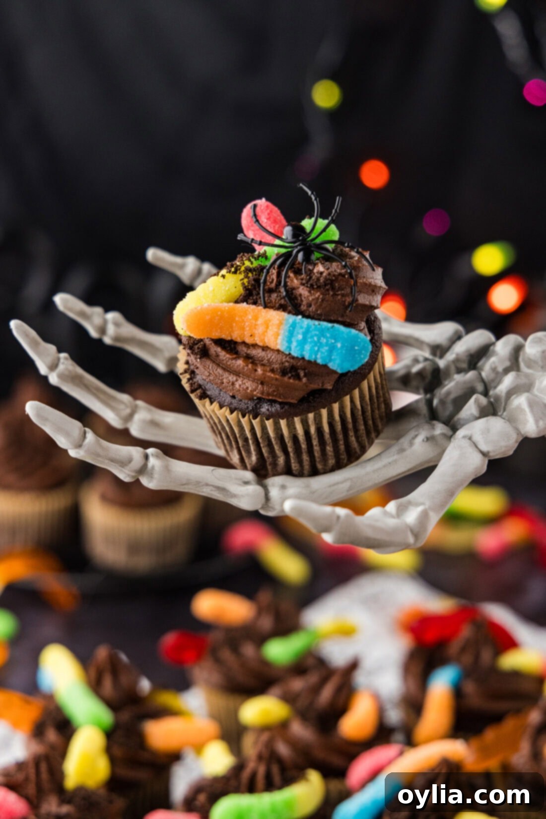 Skeleton hand holding a Halloween Dirt Cupcake
